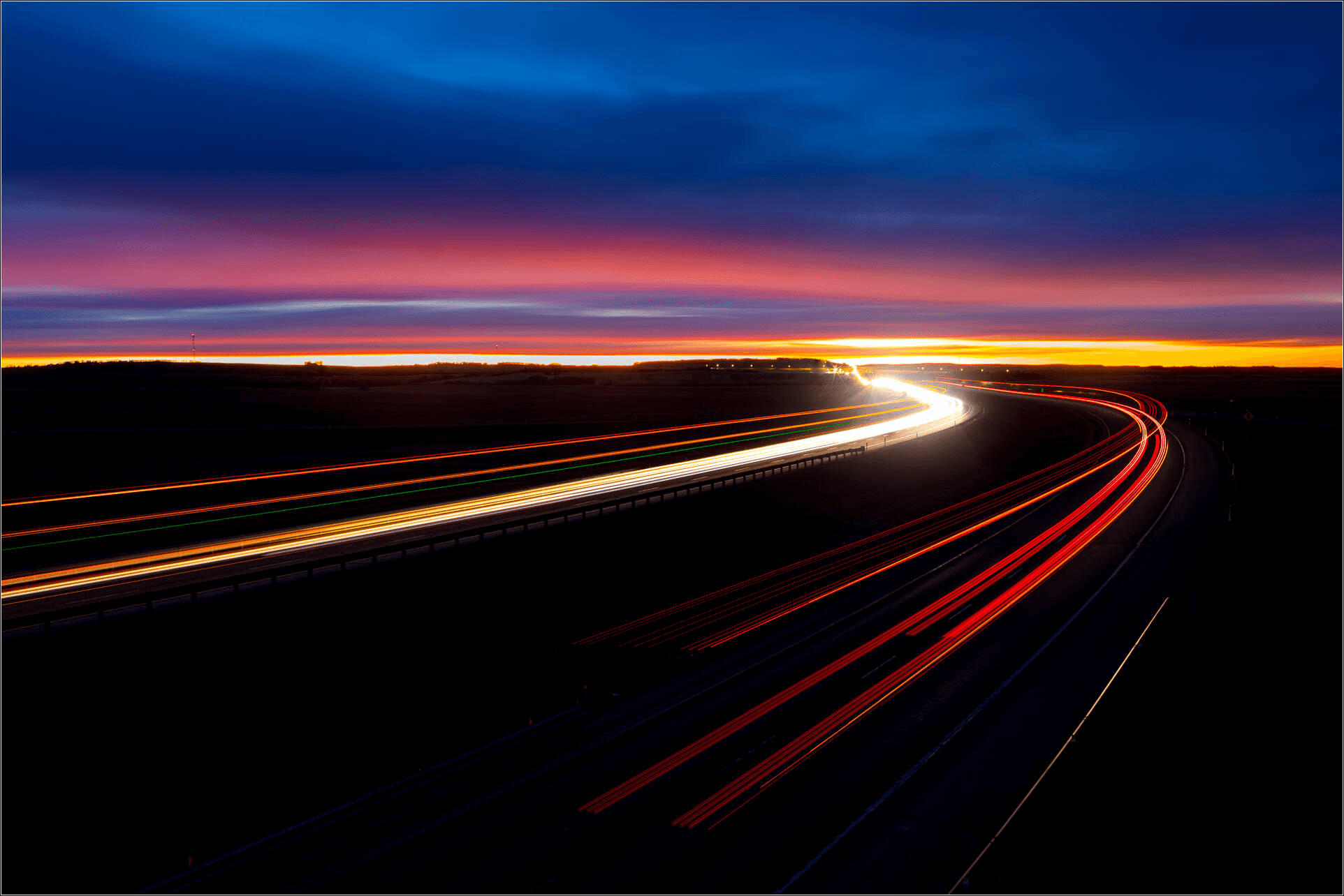Automotive road with light trails representing digital transformation